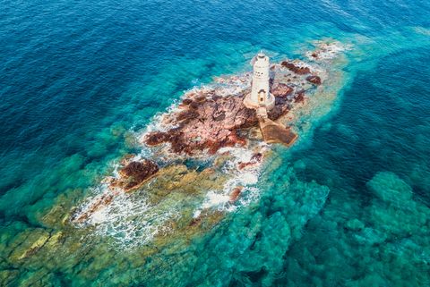 mangiabarche lighthouse in the middle of the mediterranean sea sant antioco, sulcis, sardinia, italy