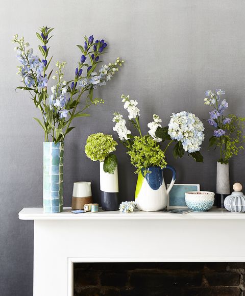 mantelscaping, mantelpiece with ceramic vases filled with fresh flowers