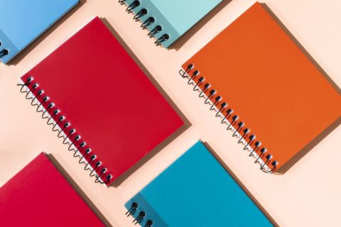 many colorful notepads on a pastel background