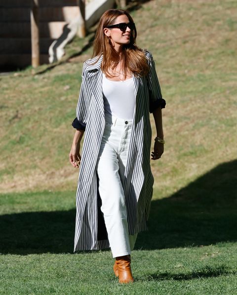Mar Soura in white jeans and a trench coat at the Longines Global Champions Tour