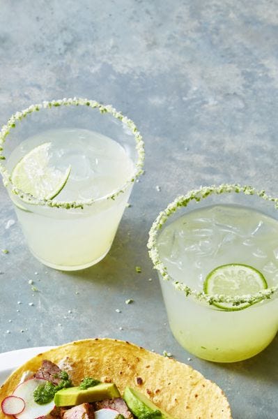 two glasses of a classic lime margarita with a salty rim