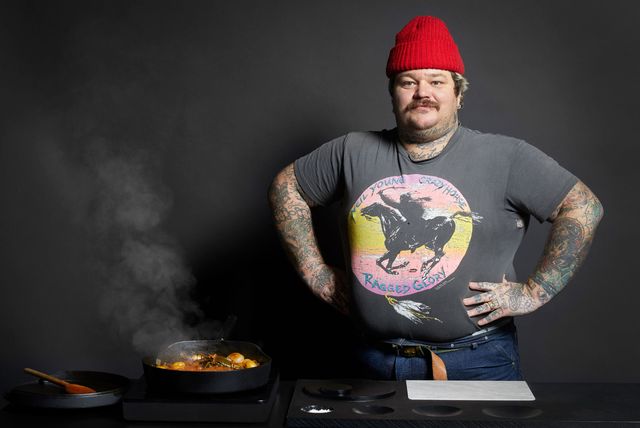 man standing next to steaming pan