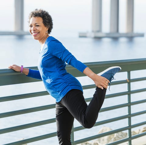 Mature African-American woman exercising on waterfront