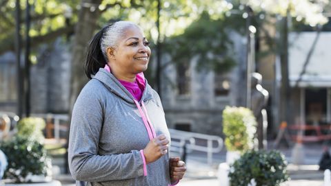 Mature African-American woman jogging in city