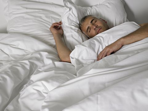 mature man sleeping in bed, elevated view