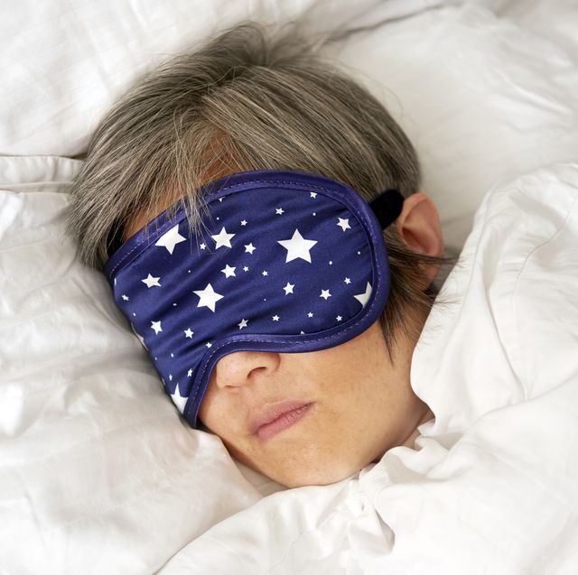 mature woman sleeping in bed with eye mask close u