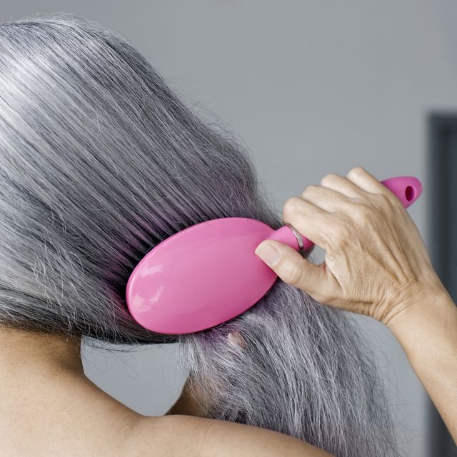 mature woman with hair brush