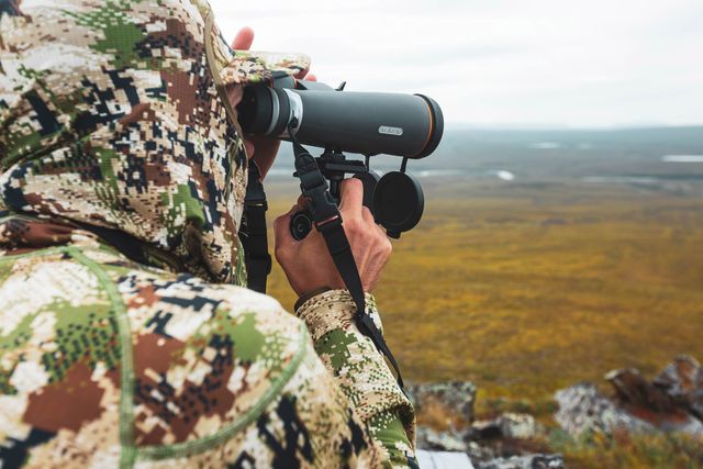 army man looking through binoculars