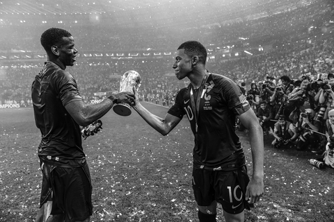 moscow, russia july 15 editors note this image has been converted to black and white paul pogba l and kylian mbappe of france celebrate victory with the world cup trophy following his side victory in the 2018 fifa world cup russia final between france and croatia at luzhniki stadium on july 15, 2018 in moscow, russia photo by david ramos fifafifa via getty images