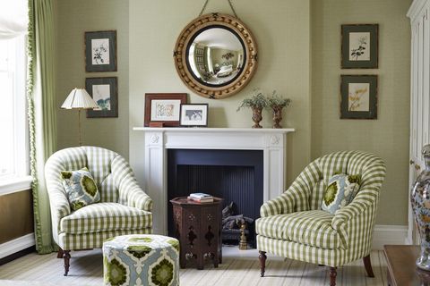 char­ming checks and soft upholstered walls in shades of honeydew make for an inviting guest room