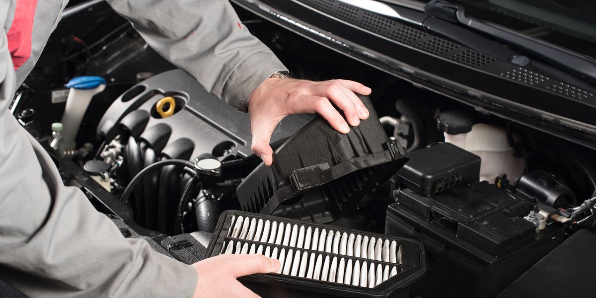 mechanic changing the air filter on a car royalty free image
