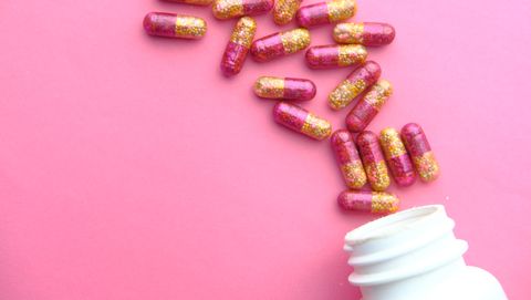 medical capsules on pink background