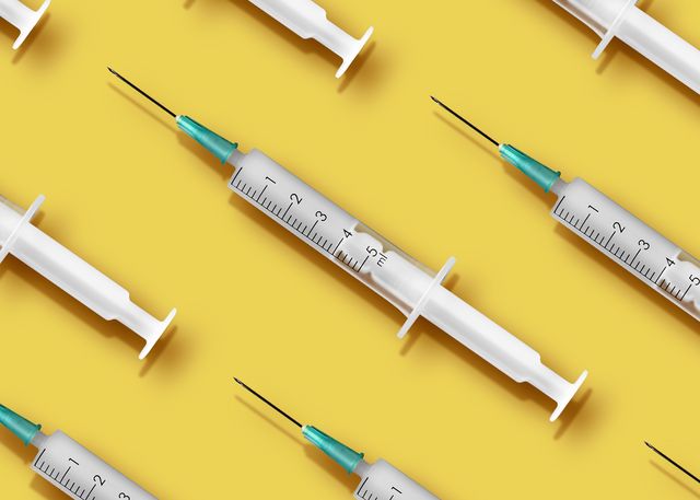 medical syringes organized in a pattern on yellow background