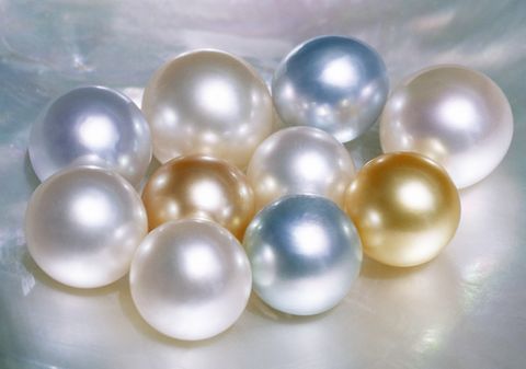 cultured pearls in various hues on oyster shell