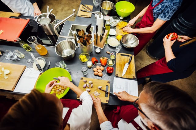 members of a cooking class preparing food