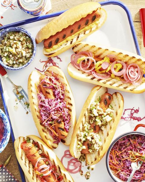 platter of 5 grilled hotdogs with creative toppings for memorial day