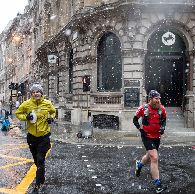men jogging during snow fall across the capital