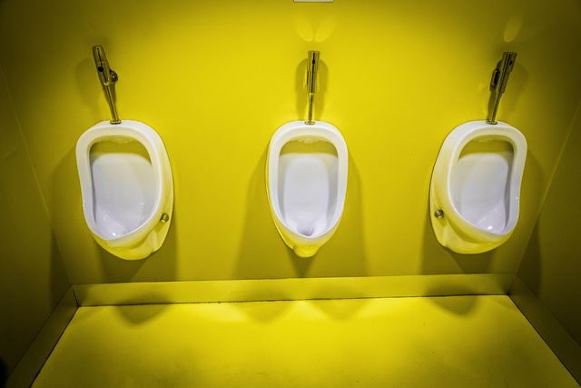 men's public toilets on a yellow background