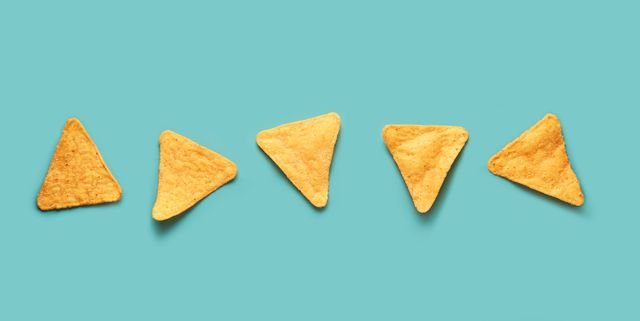 mexican nacho corn chips lying on a blue turquoise background mexican cuisine