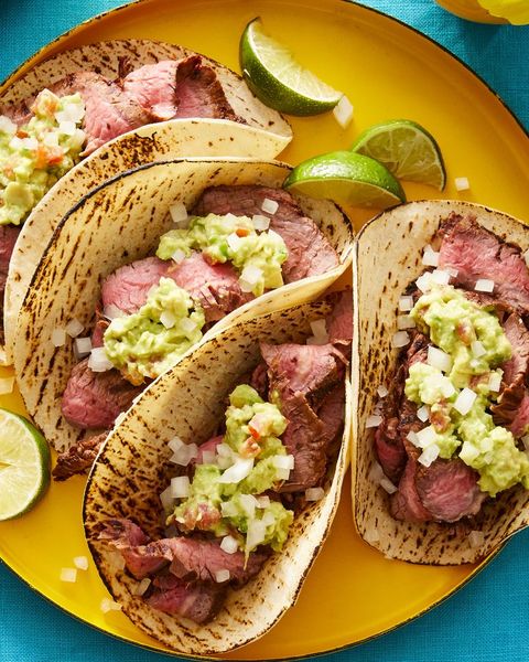 mexican recipes chipotle carne asada tacos with limes on yellow plate