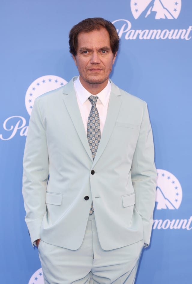 michael shannon standing with hands in pockets wearing a light grey suit