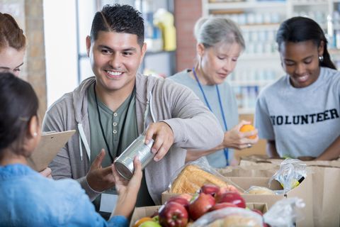 Mid adult Hispanic man volunteers during food drive