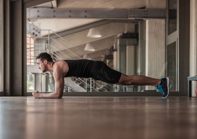 mid adult man doing plank exercise
