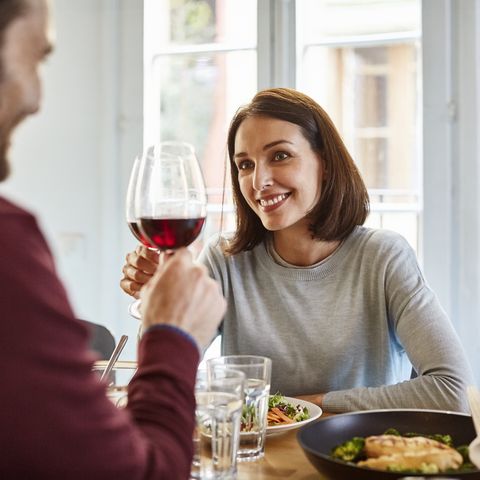 mid adult woman toasting wine glass with man