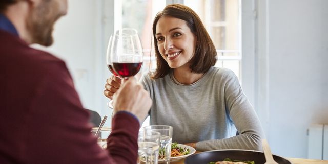mid adult woman toasting wine glass with man
