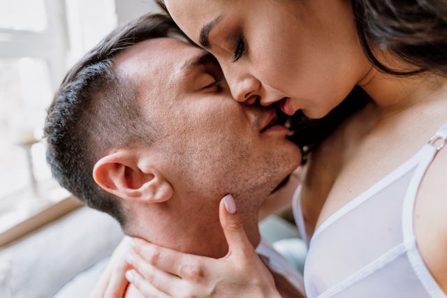 midsection of couple kissing