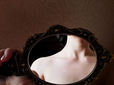 Midsection Of Naked Woman Seen In Mirror At Home