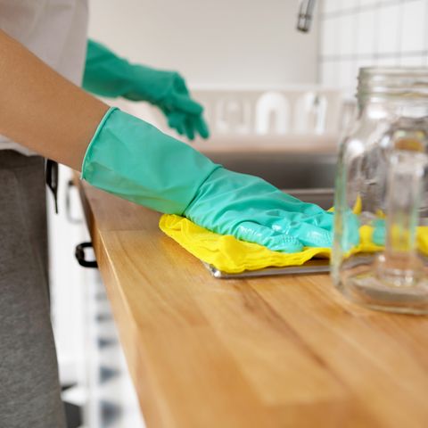midsection of woman cleaning kitchen counter