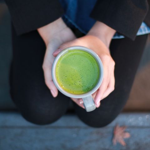 a cup of brewed hot matcha tea, which can help boost your holistic health over time