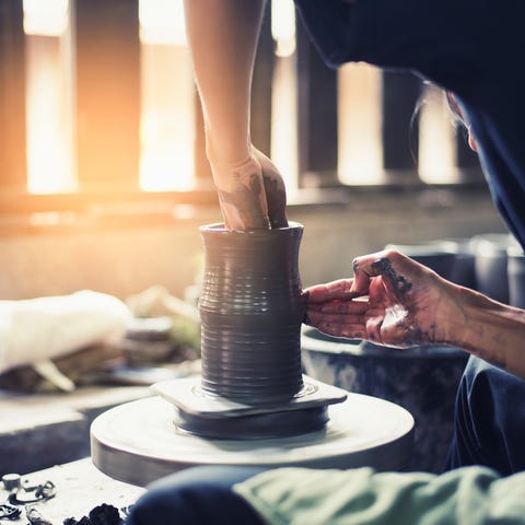 midsection of woman making pottery in workshop