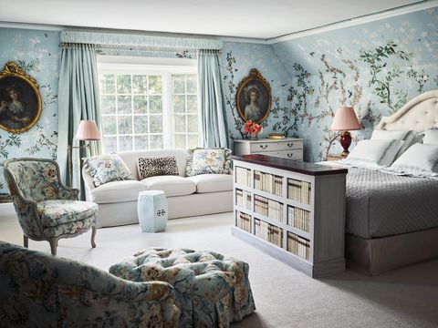 a blue bedroom with floral wallpaper