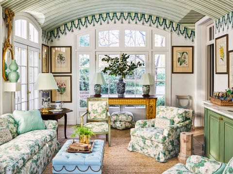 a striped and curved ceiling and seagrass carpet and floral upholstered furniture