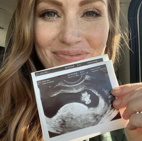 Mina Starsiak Hawk  holds ultrasound of her second child