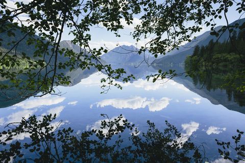 mirror reflections, the sky and clouds reflected in the surface of hte water of lake crescent