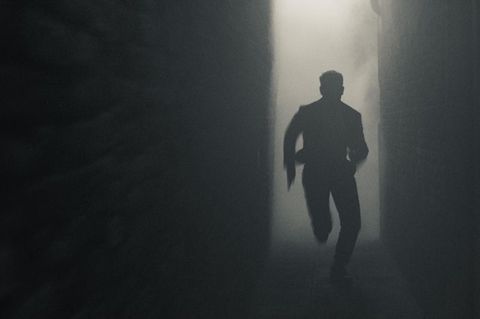 Tom Cruise runs through a dark and smoky environment in Mission Impossible 7 Still