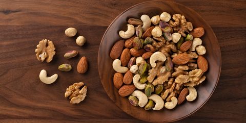 mixed nuts assortment in a wood bowl