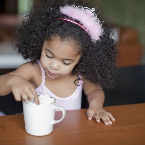 mixed race girl drinking hot chocolate