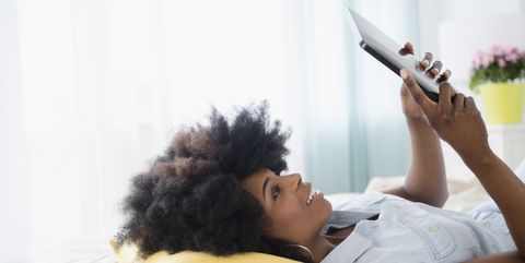 mixed race woman using digital tablet