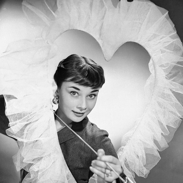 original caption broadways newest sweetheart, bewitching briton audrey hepburn, makes a lovely valentine decoration, complete with cupid like smile and arrow the young actress, starring in the play, gigi, will soon be married to james hanson, a london businessman