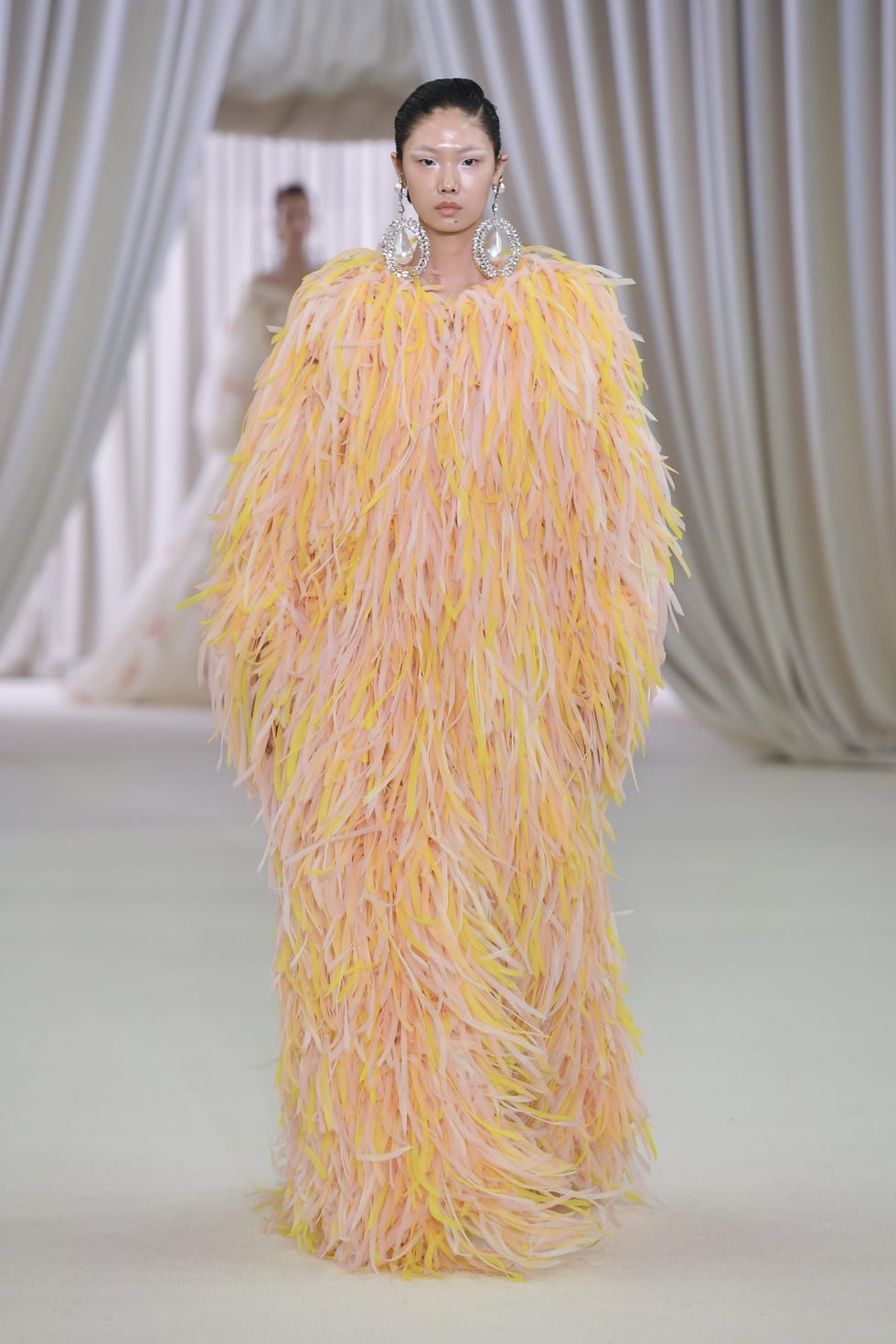 Giambattista Valli's couture presentation is wowed with ultra-voluminous dresses, liquid metallics, and lovely, vibrant pastels, as he is always one to enjoy the indulgence.