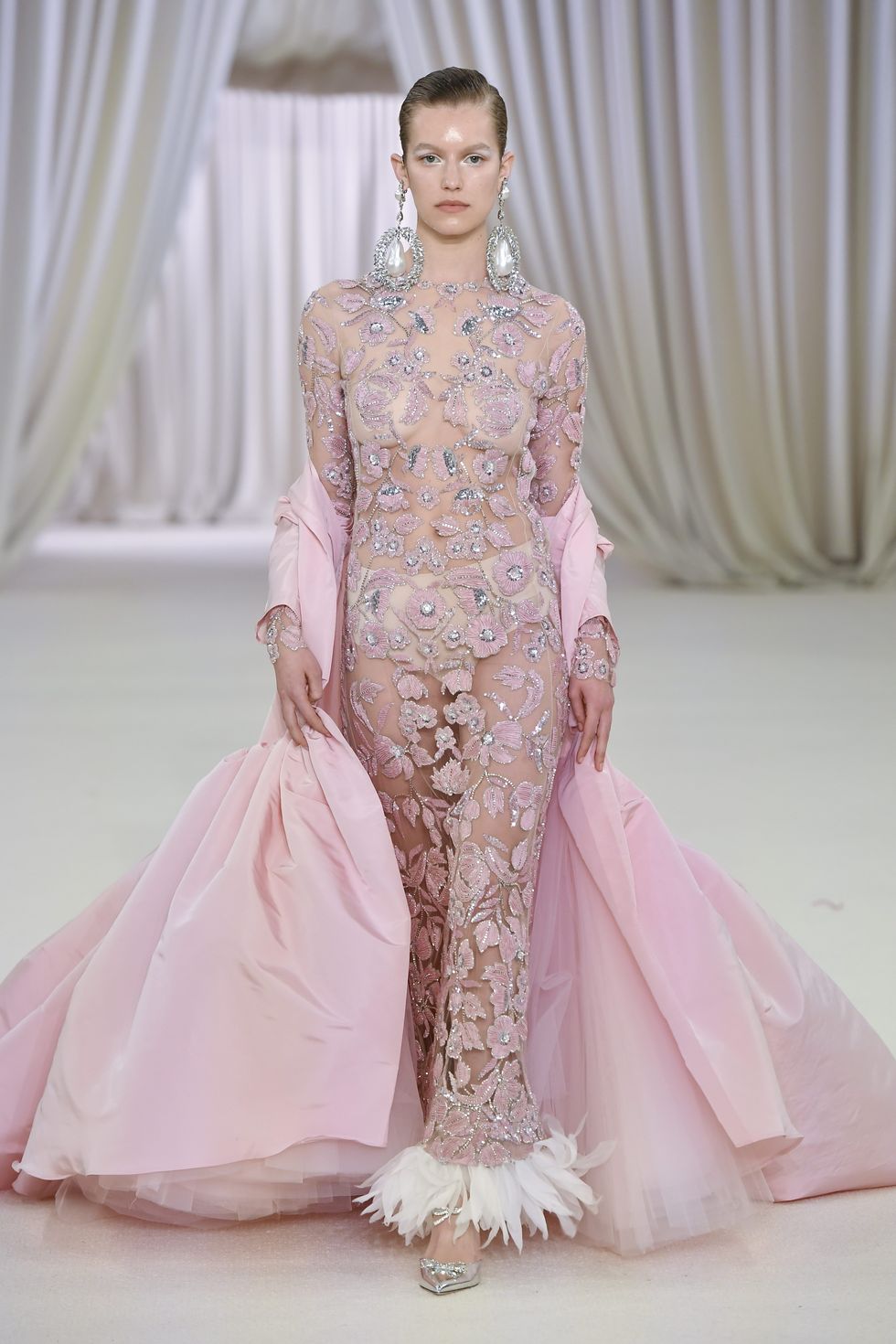 Giambattista Valli's couture presentation is wowed with ultra-voluminous dresses, liquid metallics, and lovely, vibrant pastels, as he is always one to enjoy the indulgence.