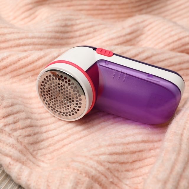 modern fabric shaver for lint removing and sweater on wooden table