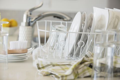 Modern white dishes drying in rack.