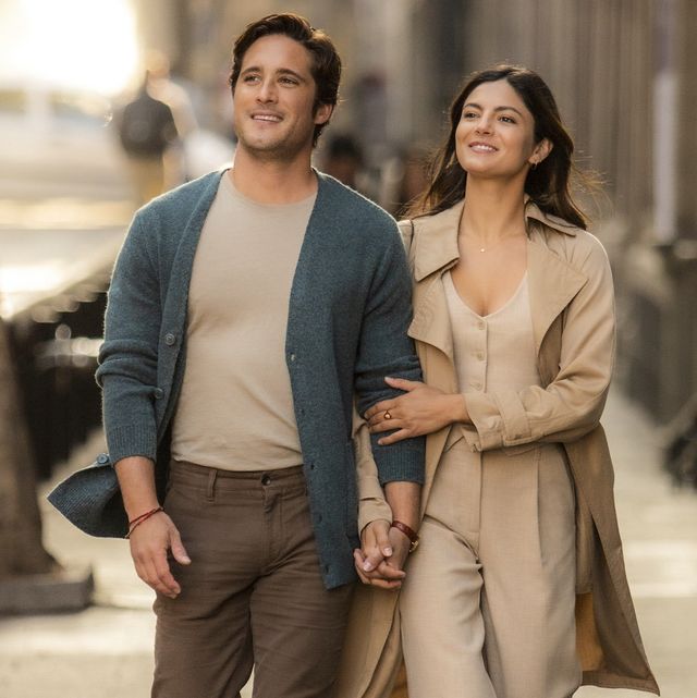 diego boneta and monica barbaro star in at midnight, they walk down a street holding hands and smiling