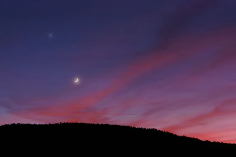 moon and mars against orange pink clouds