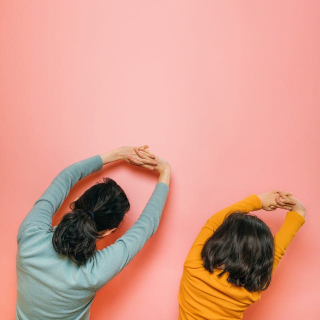 mother and daughter doing stretching together